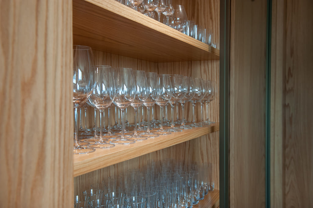 Cristaleira planejada em madeira na reforma do apartamento no Belvedere, Belo Horizonte, realizada pela Mazí Construtora.